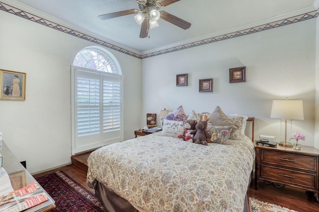 bedroom featuring ornamental molding, baseboards, a ceiling fan, and wood finished floors