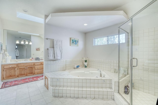 full bath featuring vanity, a shower stall, a jetted tub, and tile patterned flooring