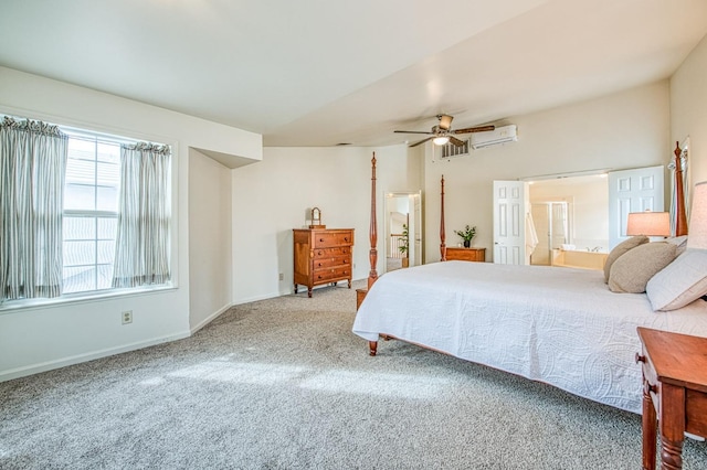 bedroom with baseboards, an AC wall unit, carpet flooring, ensuite bathroom, and a ceiling fan