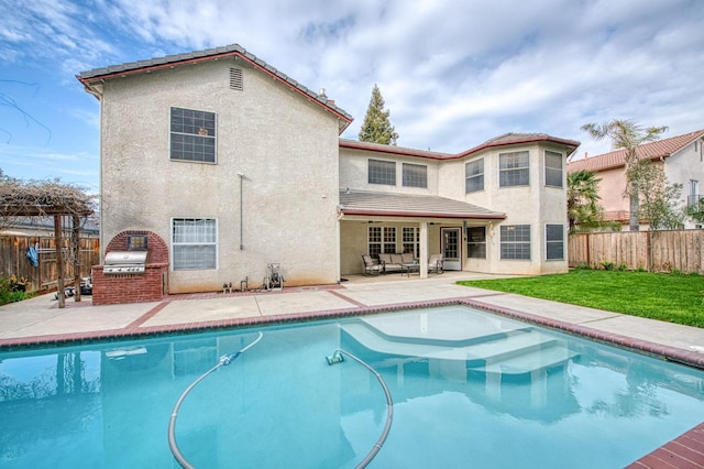 back of property featuring stucco siding, a patio, and a fenced backyard