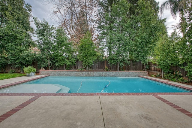 view of swimming pool featuring a fenced in pool, a fenced backyard, and a patio area