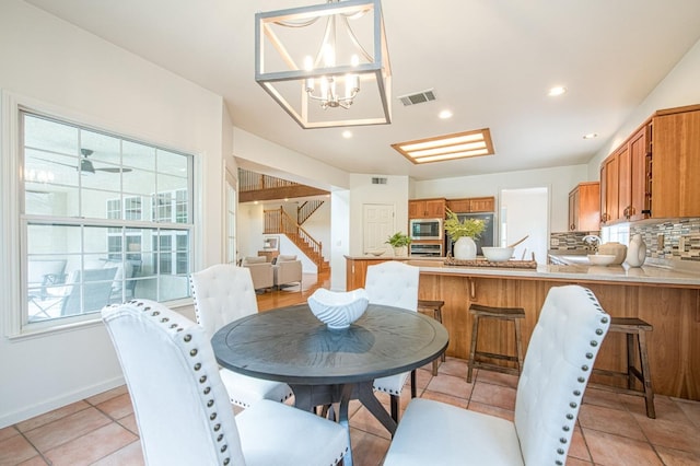 dining area featuring stairway, a notable chandelier, recessed lighting, and visible vents