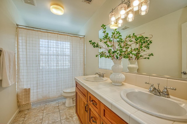 bathroom featuring tile patterned floors, visible vents, toilet, and a sink