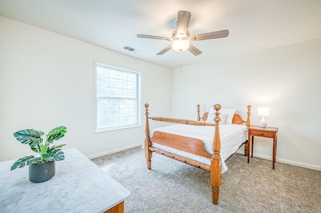 bedroom featuring ceiling fan, light colored carpet, visible vents, and baseboards