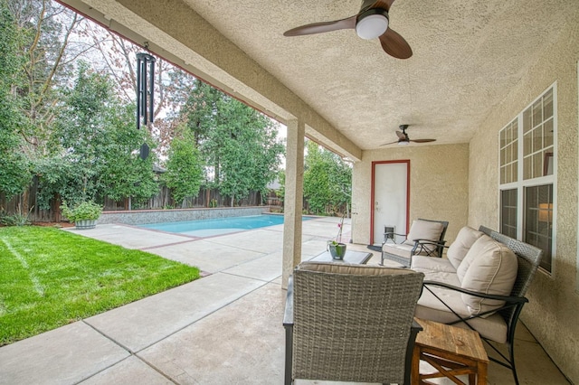 view of patio / terrace with a ceiling fan, a fenced backyard, and a fenced in pool