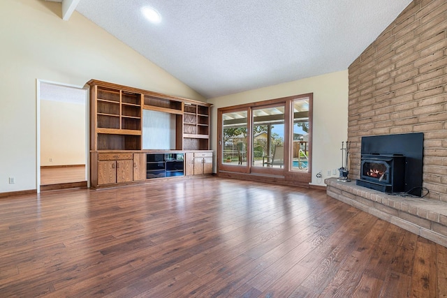 unfurnished living room featuring high vaulted ceiling, a textured ceiling, wood-type flooring, a fireplace, and baseboards