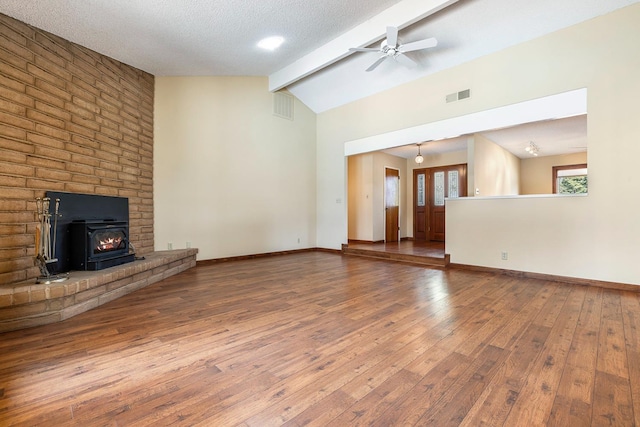 unfurnished living room with visible vents, vaulted ceiling with beams, baseboards, and wood-type flooring