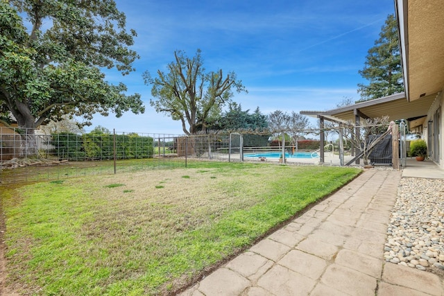 view of yard with a fenced in pool, a fenced backyard, and a patio area