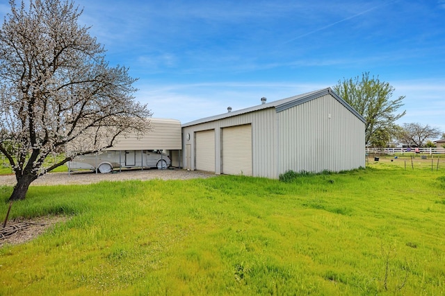 view of outbuilding featuring an outdoor structure and fence