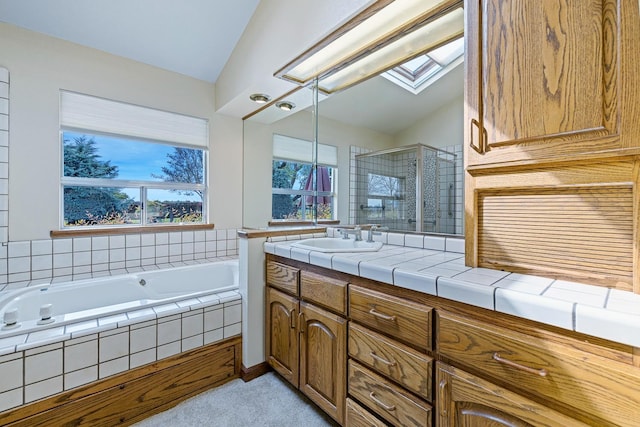 bathroom with lofted ceiling with skylight, a stall shower, vanity, and a bath