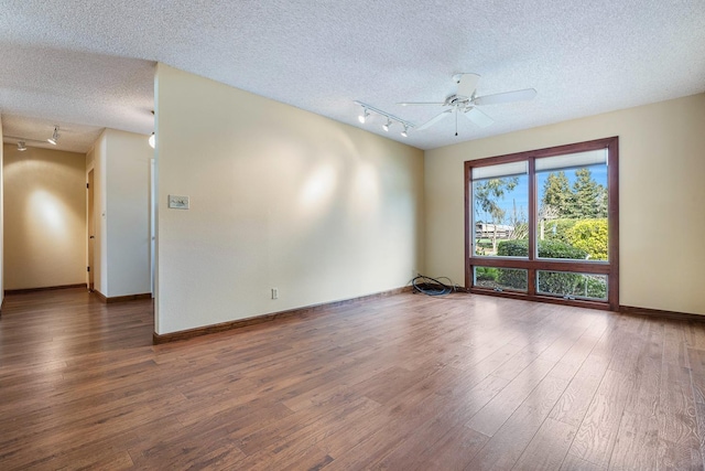 unfurnished room with track lighting, a textured ceiling, wood finished floors, baseboards, and ceiling fan