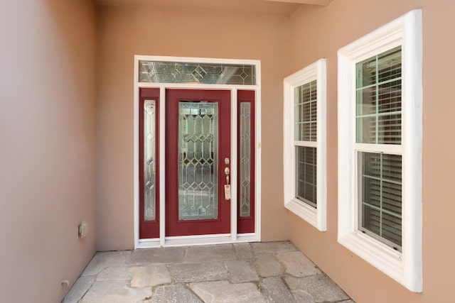 property entrance with stucco siding