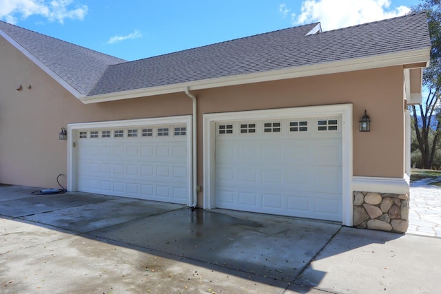 garage with concrete driveway