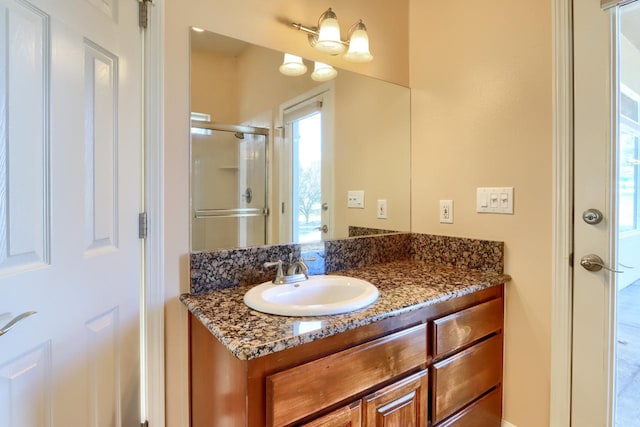 full bath featuring a shower stall and vanity