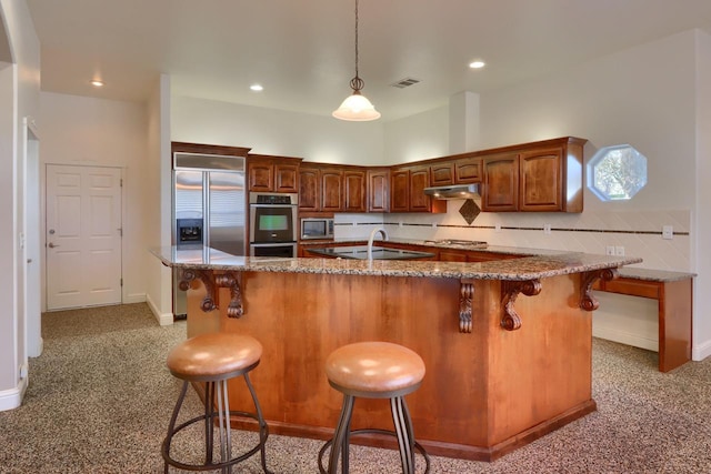 kitchen featuring visible vents, stone countertops, under cabinet range hood, appliances with stainless steel finishes, and light carpet