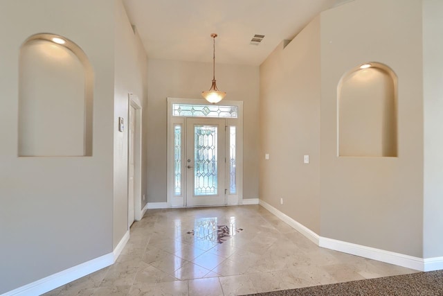 foyer entrance featuring baseboards