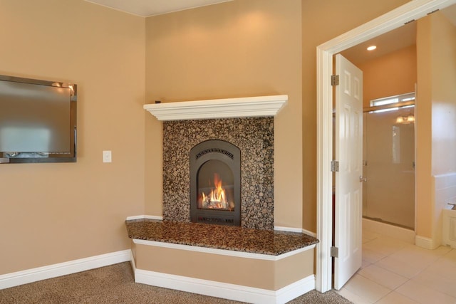 room details featuring a fireplace and baseboards