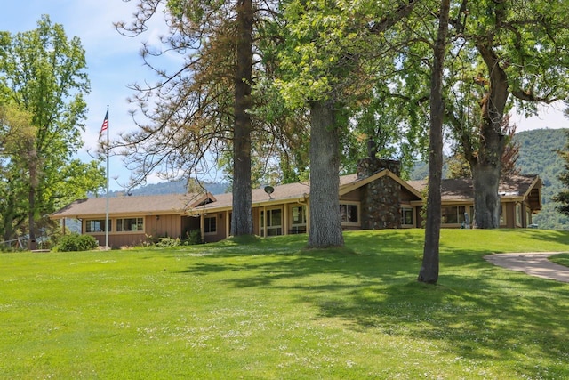 view of front of property featuring board and batten siding and a front yard