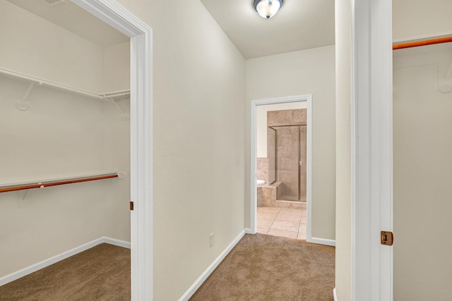 corridor featuring carpet flooring and baseboards