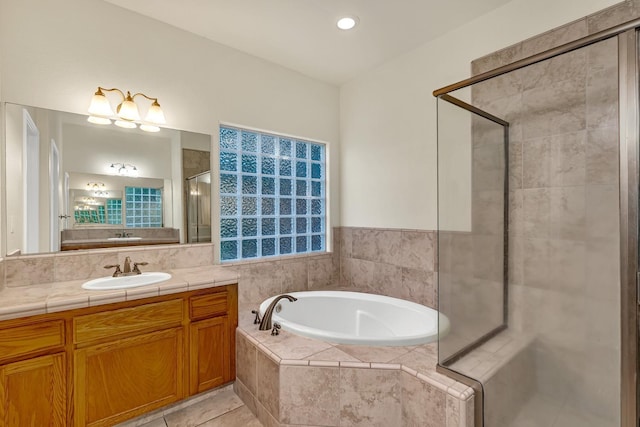 full bath with vanity, a garden tub, a stall shower, and tile patterned floors