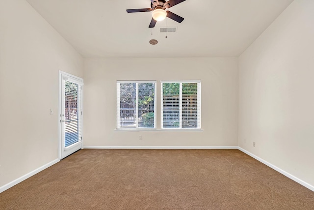 carpeted spare room featuring a ceiling fan, baseboards, and visible vents