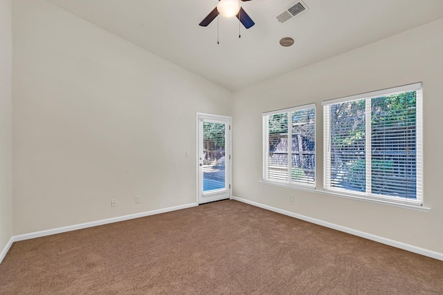 spare room with baseboards, lofted ceiling, carpet floors, and a ceiling fan