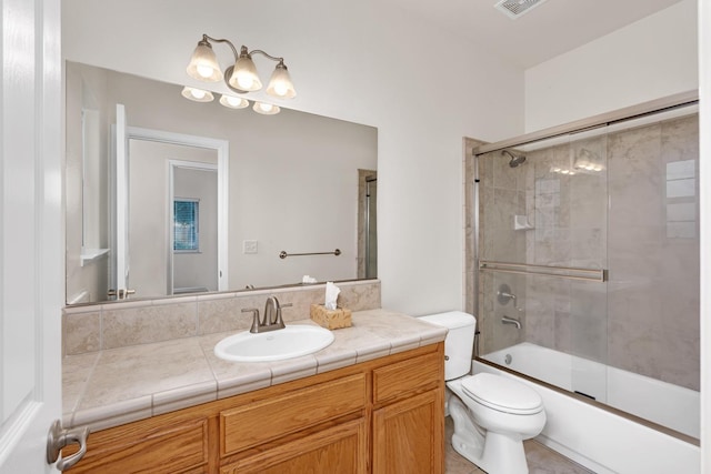 full bathroom with enclosed tub / shower combo, toilet, and vanity