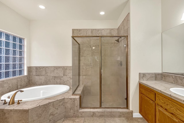 bathroom featuring recessed lighting, a stall shower, vanity, and a garden tub