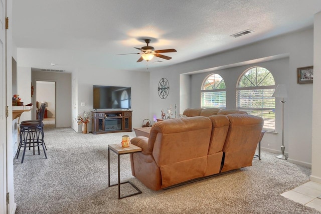 29878 Deer Trail Ln, Coarsegold, CA 93614 - carpeted living area featuring visible vents, baseboards, a ceiling fan, and a textured ceiling