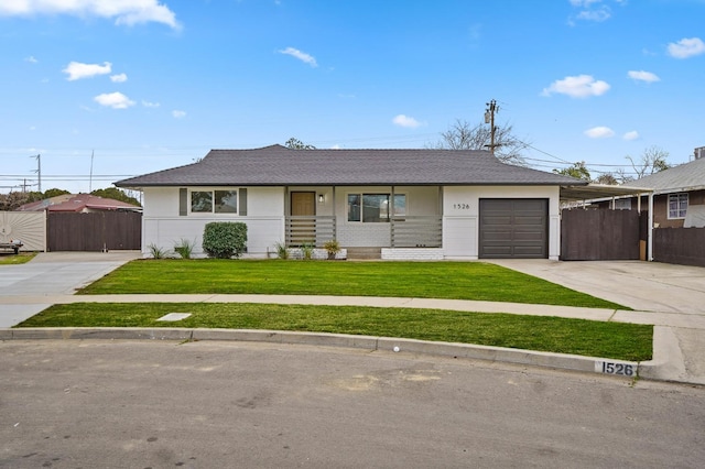 ranch-style home with a garage, driveway, a front lawn, and fence