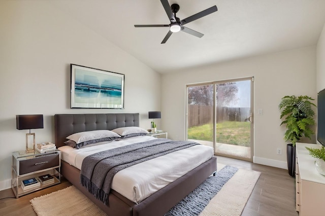 bedroom featuring access to exterior, light wood finished floors, baseboards, and lofted ceiling