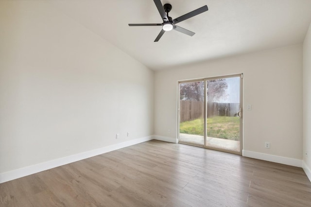 unfurnished room featuring a ceiling fan, vaulted ceiling, wood finished floors, and baseboards