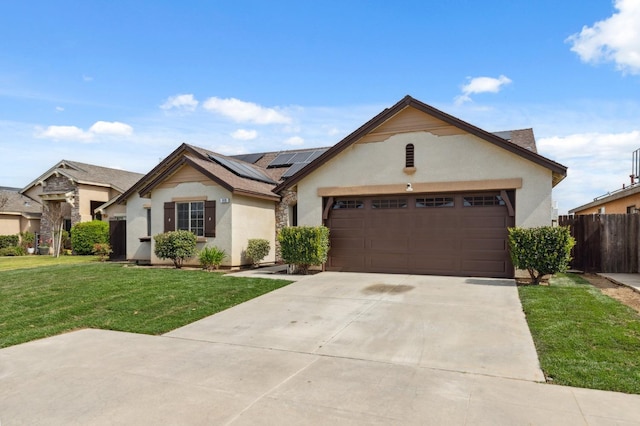 ranch-style home with a front yard, driveway, stucco siding, a garage, and roof mounted solar panels