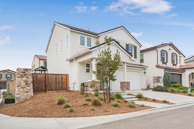 view of front of house with stucco siding, driveway, an attached garage, and fence