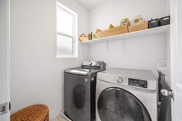 laundry room featuring baseboards, independent washer and dryer, and laundry area