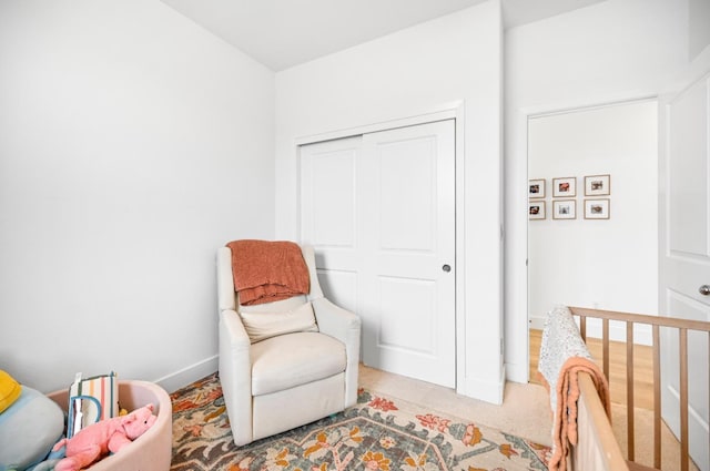 sitting room with light carpet and baseboards