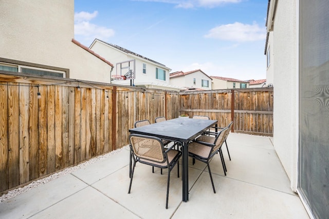 view of patio / terrace with outdoor dining area and fence