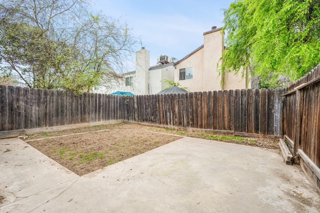 view of yard with a patio and a fenced backyard