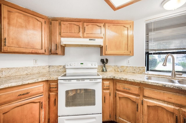 3622 W Terrace Ave, Fresno, CA 93722 - kitchen with electric stove, under cabinet range hood, a sink, and light stone counters