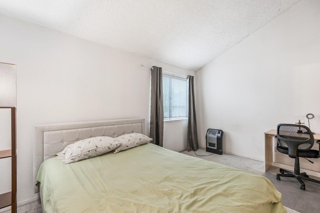 bedroom with carpet floors, a textured ceiling, and vaulted ceiling