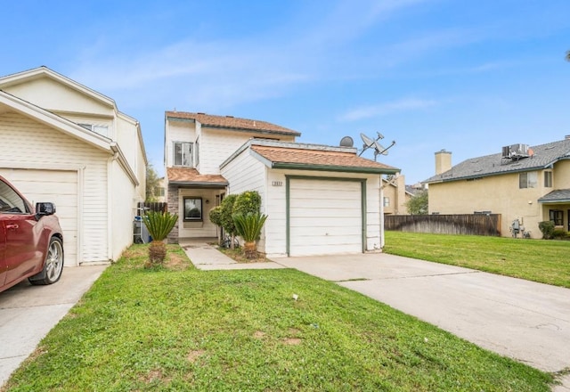 traditional home featuring concrete driveway, a front lawn, and fence