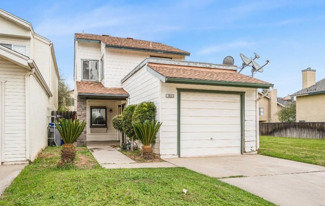 traditional home with driveway, a shingled roof, a front yard, and fence