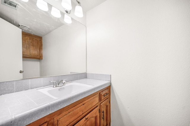 bathroom featuring visible vents and vanity