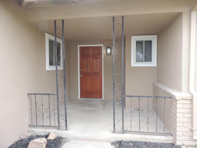 entrance to property featuring stucco siding