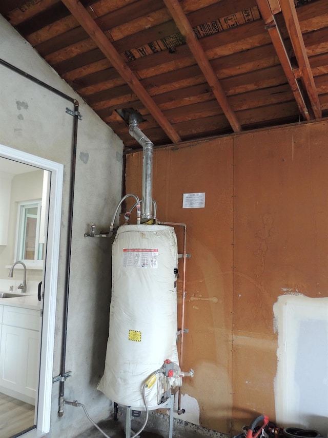 utilities with gas water heater and a sink