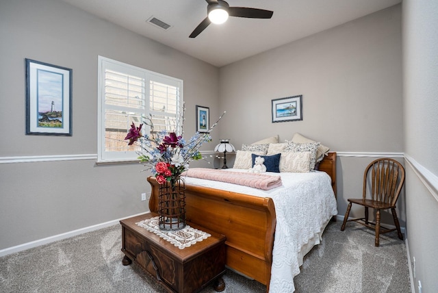 carpeted bedroom featuring visible vents, baseboards, and a ceiling fan