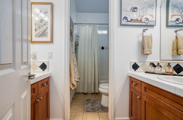 full bathroom featuring tile patterned flooring, toilet, vanity, and shower / tub combo