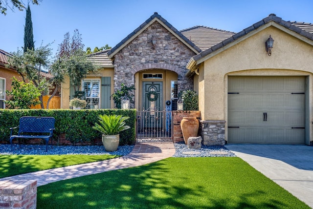 view of front facade with driveway, stucco siding, a garage, stone siding, and a tiled roof