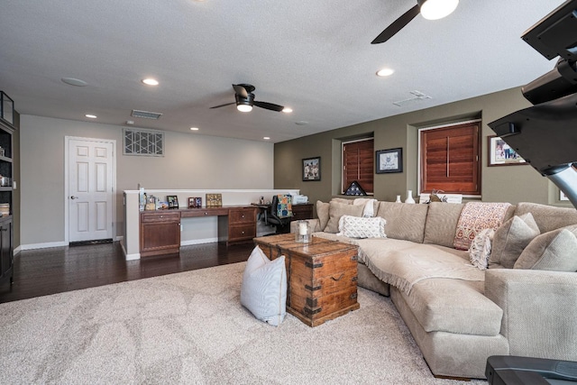 living area with dark wood finished floors, recessed lighting, visible vents, and a ceiling fan