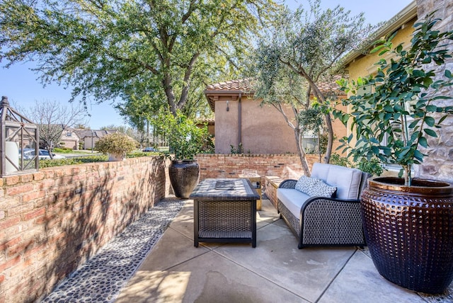 view of patio / terrace featuring outdoor lounge area and fence